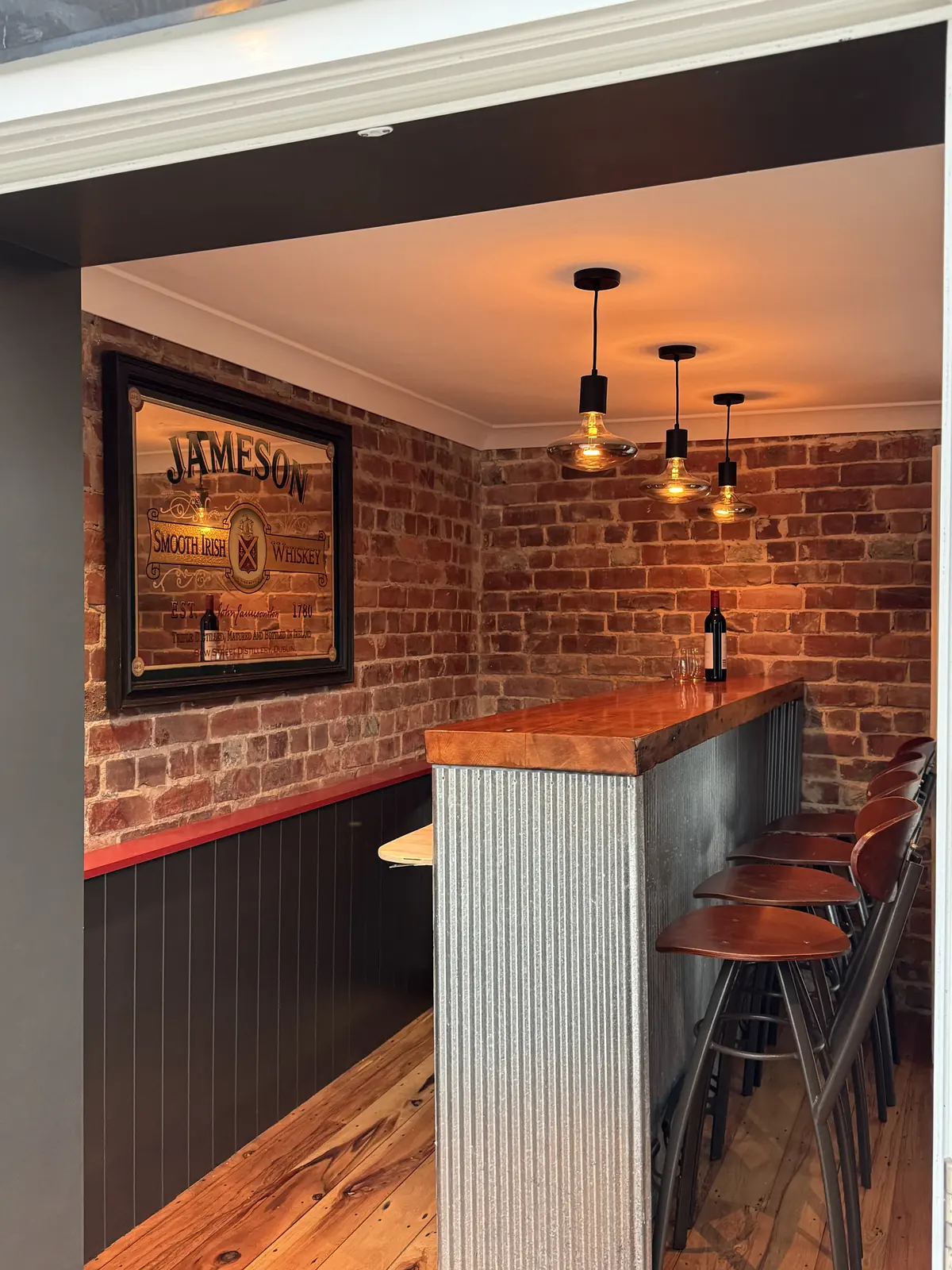 Home bar with a brick feature wall