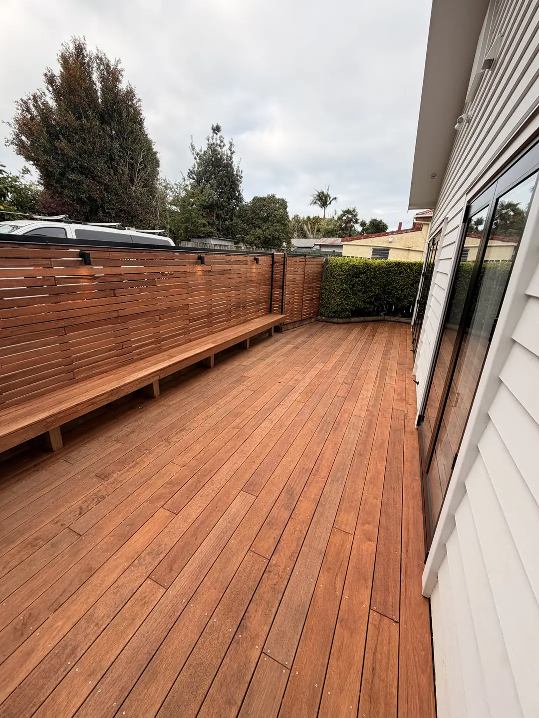Timber deck with bench seating along a fence
