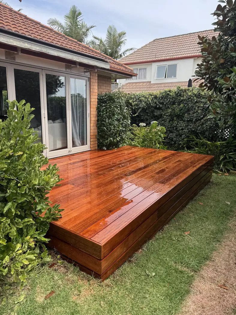 Merbau deck with a raised edge beside a brick home