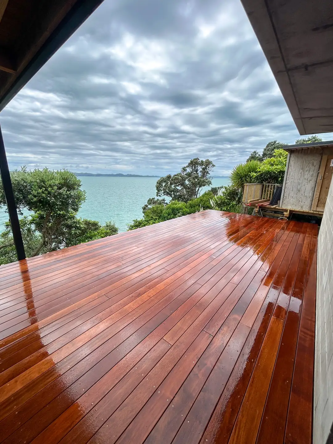 Merbau deck with glass balustrade and a sea view