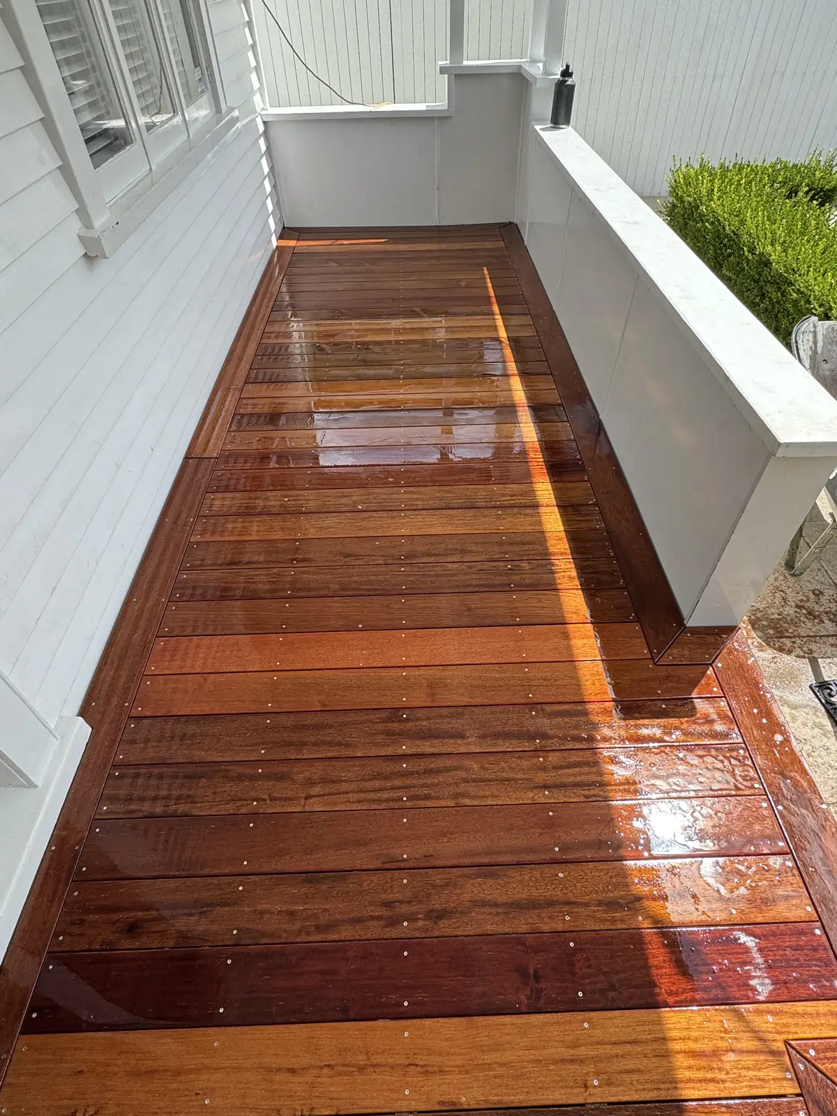 Rebuilt timber deck and walkway beside the same white villa