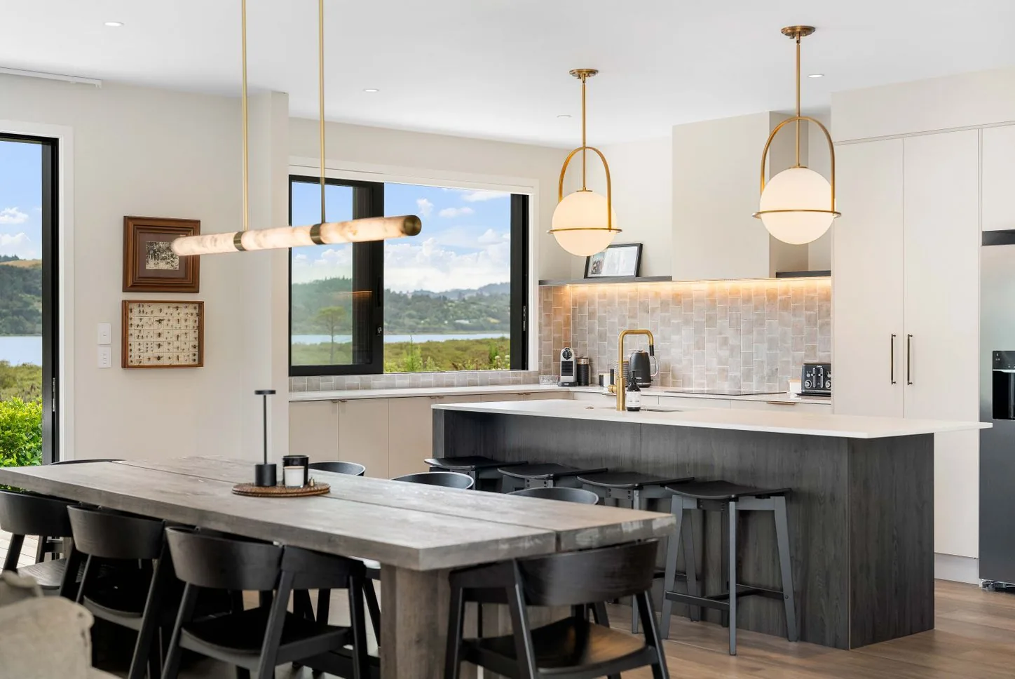Kitchen island with pendant lights and a water view