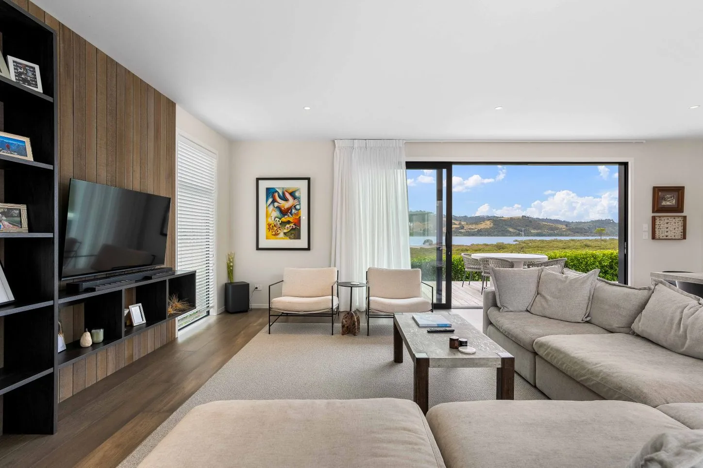Living room with a timber TV wall and sliding doors
