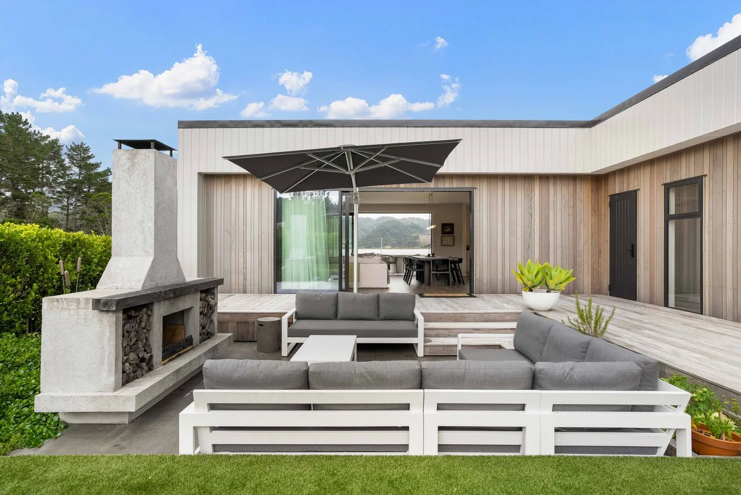 Outdoor fireplace and lounge seating in a courtyard