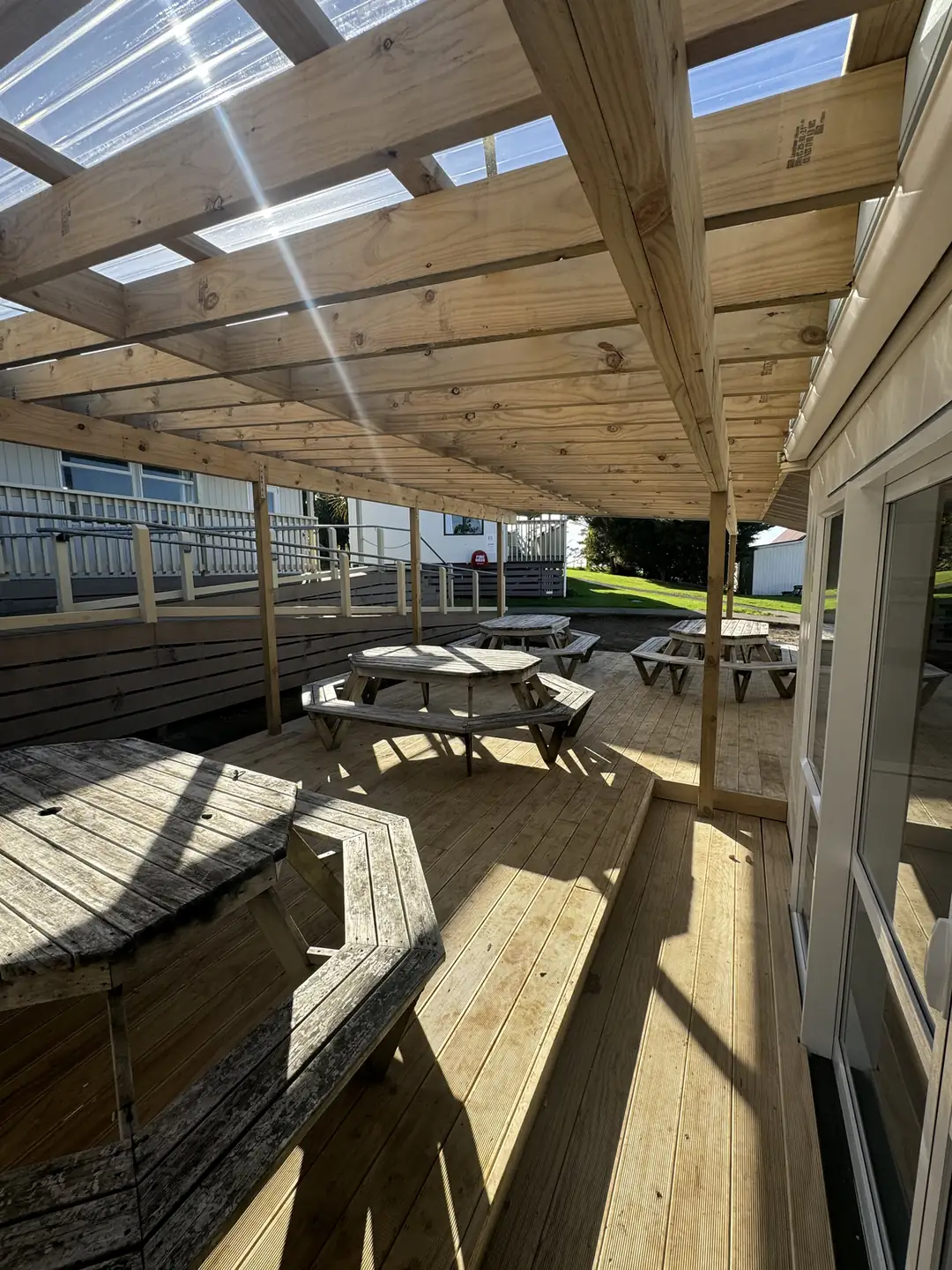 Timber pergola with a clear roof over a deck