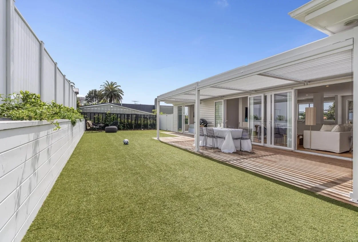 Turf lawn and louvre pergola in a side yard