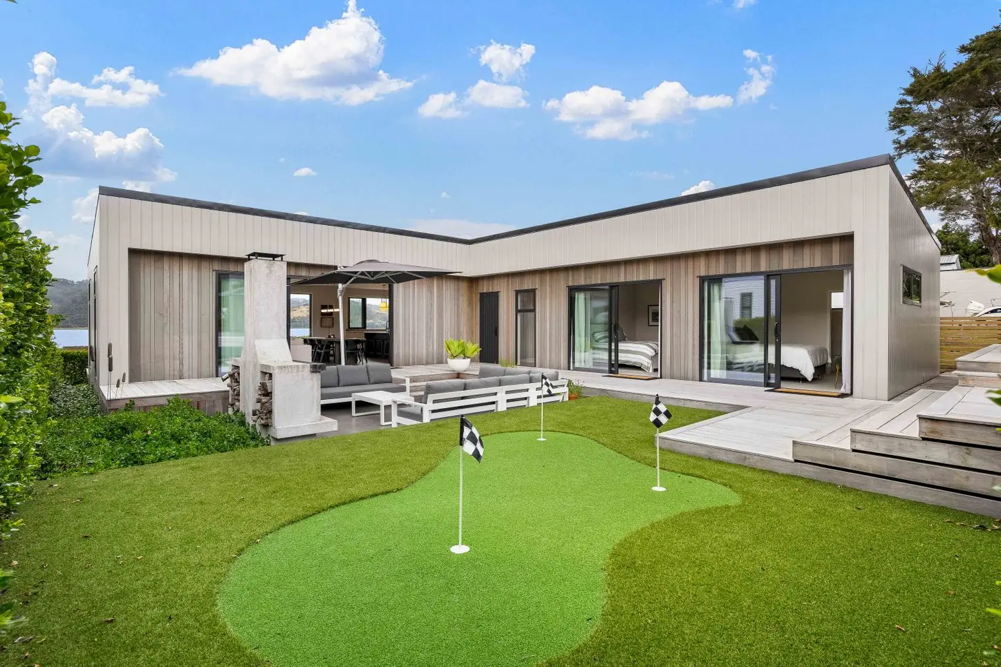 Modern home wrapped around a courtyard with a putting green