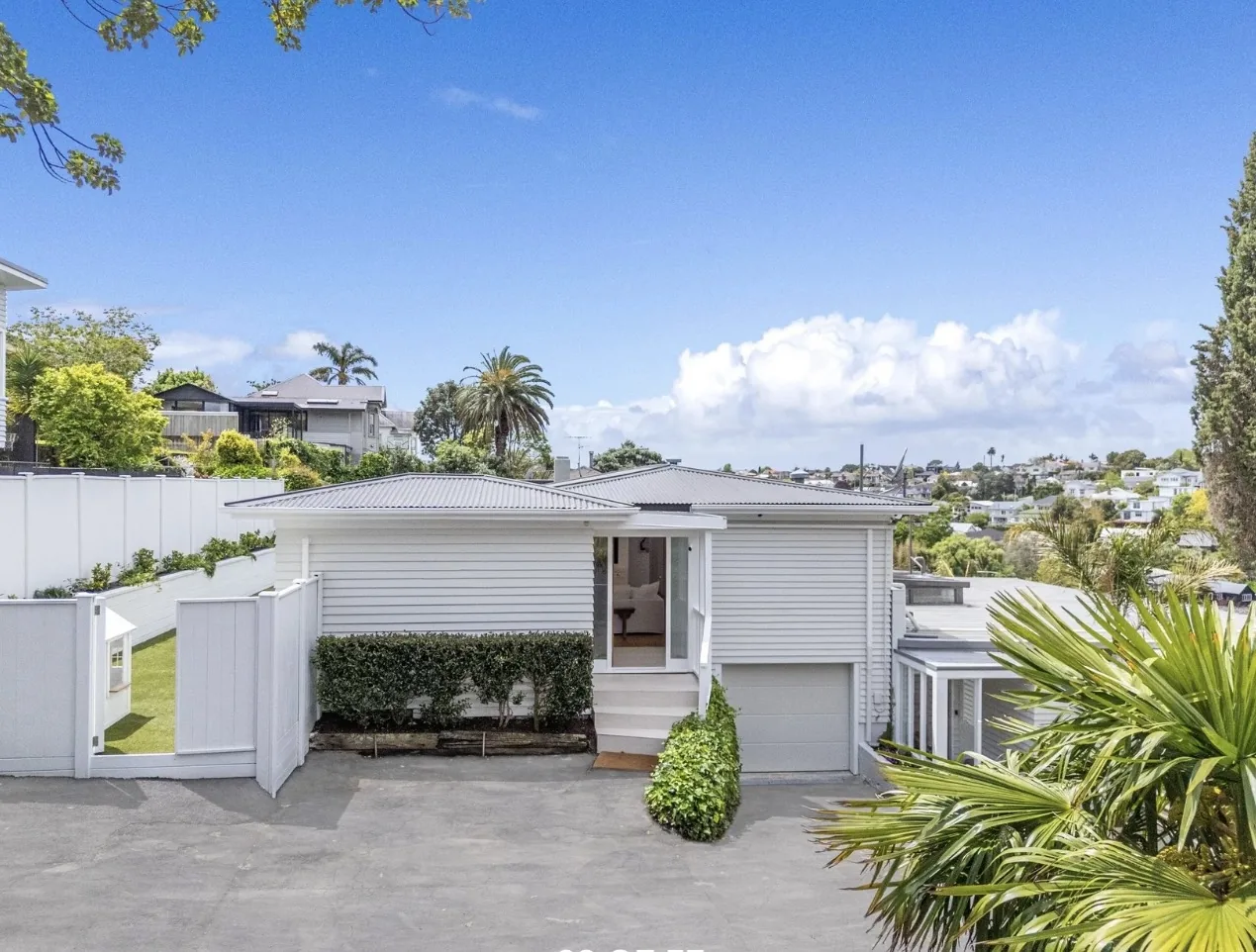 White weatherboard house seen from above, front elevation