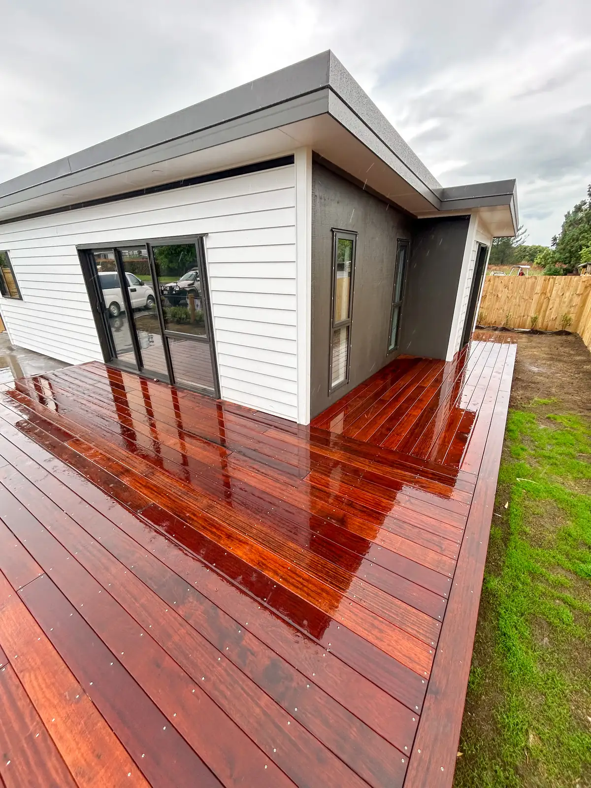 Timber deck beside a white house
